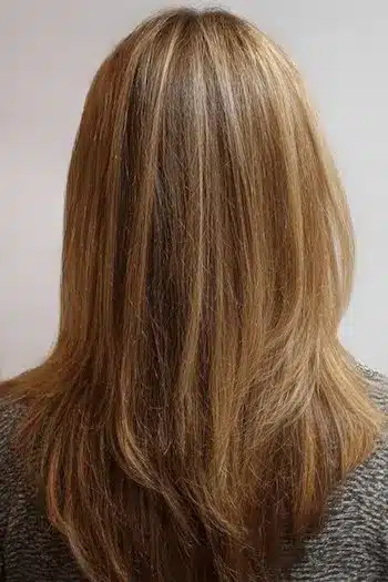 Bright highlights woven through layers, featured in 30 inspiring long hairstyles for women over 50 with fine hair.