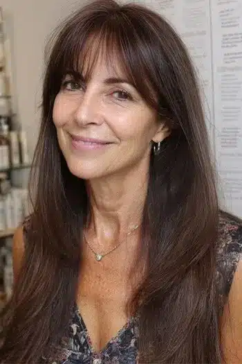 Delicate wispy bangs on long fine hair, part of 30 inspiring long hairstyles for women over 50 with fine hair.