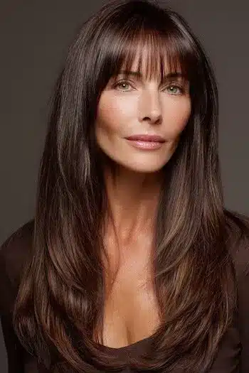 Textured shaped layers with piecey bangs, one of 30 inspiring long hairstyles for women over 50 with fine hair.