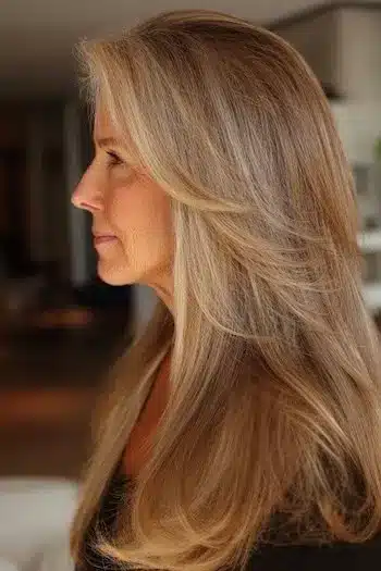 Feathered curtain bangs paired with long fine hair, part of 30 inspiring long hairstyles for women over 50 with fine hair.