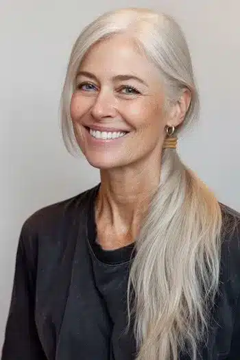 A smooth low ponytail styled for fine hair, one of the 30 inspiring long hairstyles for women over 50 with fine hair.