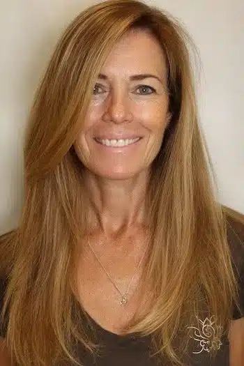 A deep side part on long fine hair, featured among 30 inspiring long hairstyles for women over 50 with fine hair.