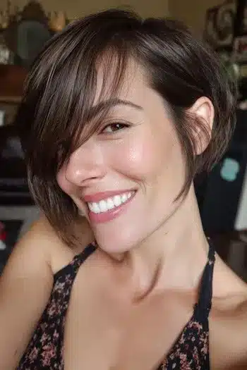 31 Bixie Haircuts That Blend Bob Shape with Pixie Ease 31 Brunette Bixie with Long Side-Swept Bangs — bixie haircuts