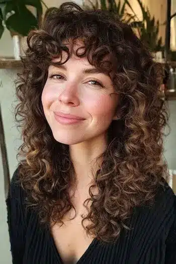 31 Hairstyles With Bangs That Prove A Little Fringe Goes A Long Way 22 Tight curls paired with a textured fringe, part of the 31 Hairstyles With Bangs That Prove A Little Fringe Goes A Long Way - Parisfy