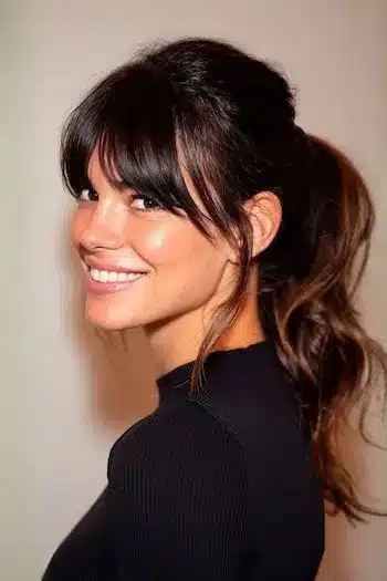 31 Hairstyles With Bangs That Prove A Little Fringe Goes A Long Way 7 A long ponytail styled with loose bangs, part of the 31 Hairstyles With Bangs That Prove A Little Fringe Goes A Long Way - Parisfy