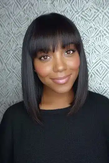 31 Hairstyles With Bangs That Prove A Little Fringe Goes A Long Way 9 A sleek long bob with a polished straight fringe, highlighting the 31 Hairstyles With Bangs That Prove A Little Fringe Goes A Long Way - Parisfy