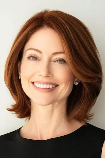 Tapered Long Bob with Flipped Ends Haircut on a smiling woman with auburn brown hair.