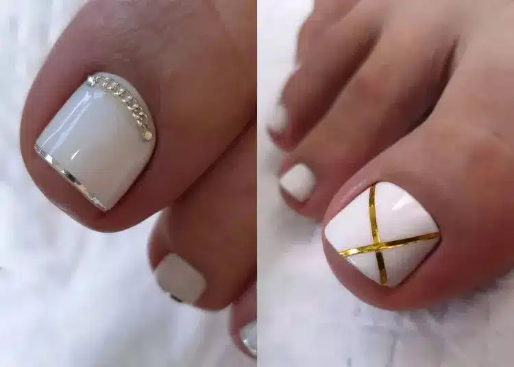 Elegant white pedicure with clean, classic polish on well-groomed toenails