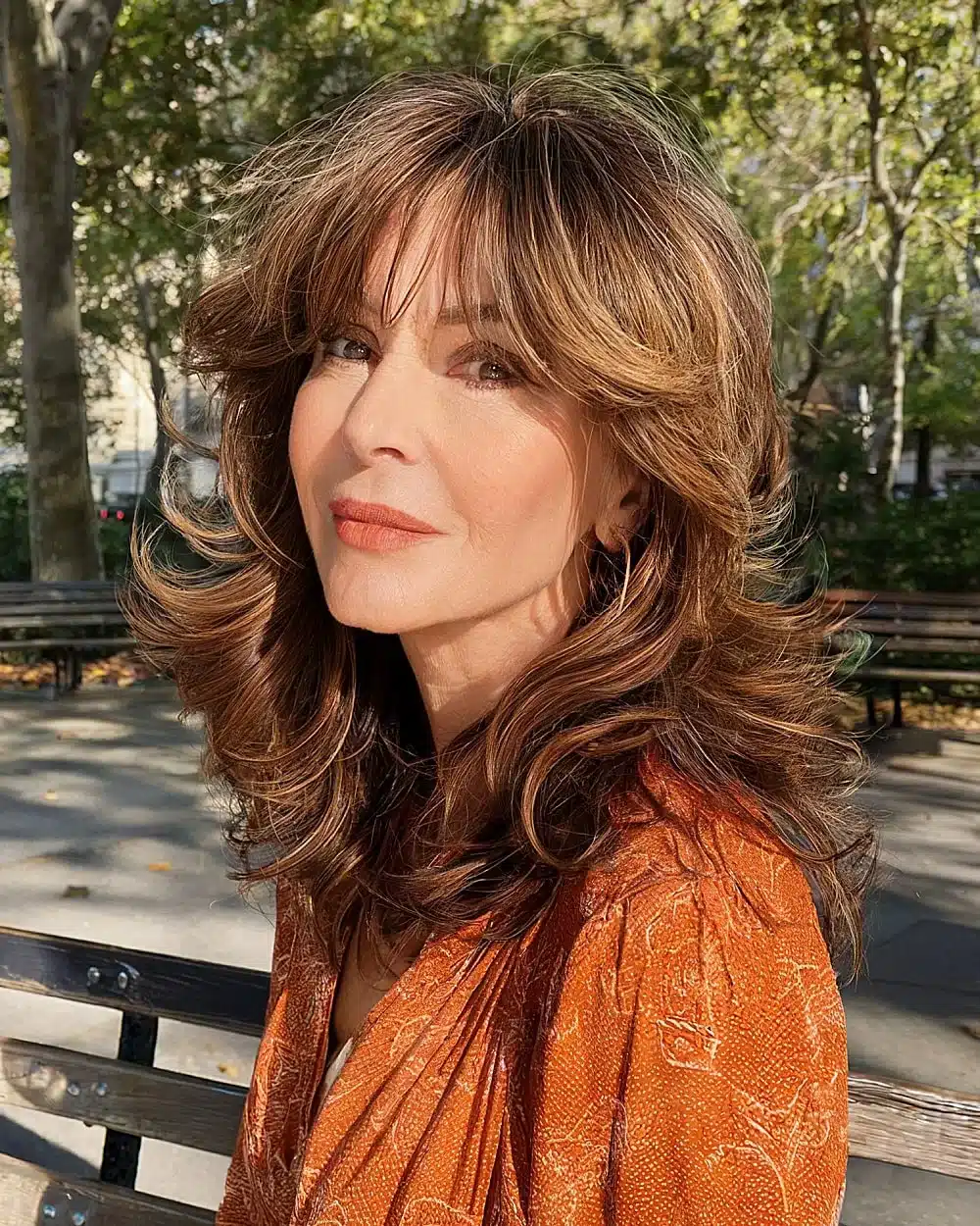 Modern 70s-inspired shag haircut with layered waves and soft bangs for women over 50, part of 20+ youthful shaggy hairstyles women over 50 are wearing in 2026