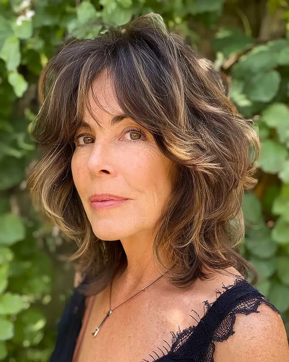Soft shag haircut with wispy layers and face-framing feathered ends for women over 50, featuring 20+ youthful shaggy hairstyles women over 50 are wearing in 2026