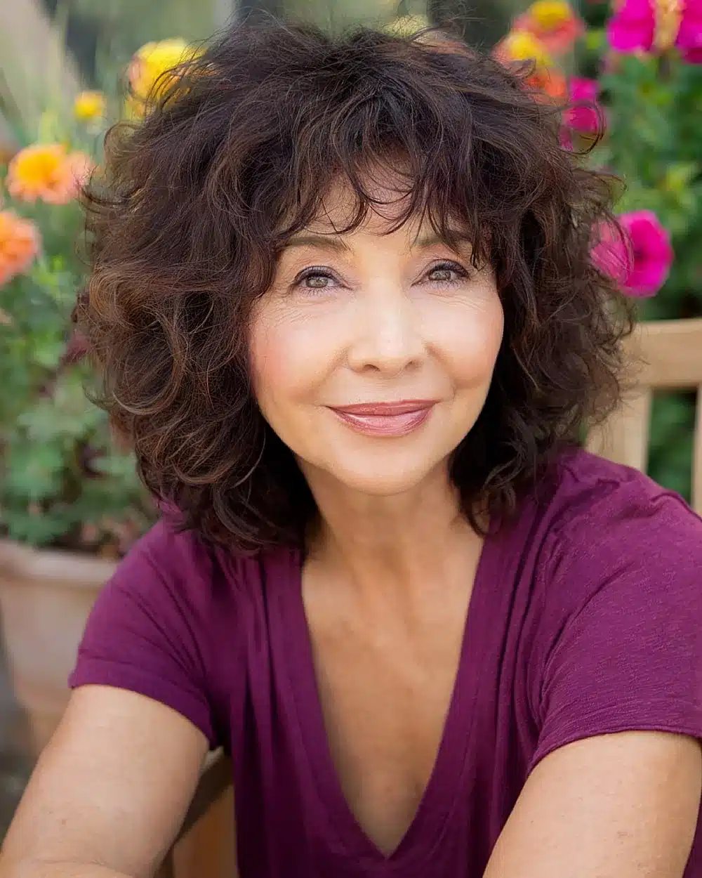 Layered shaggy haircut with volume and bangs to flatter round face shapes over 50, part of 20+ youthful shaggy hairstyles women over 50 are wearing in 2026