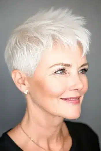 Wispy spiky silver pixie haircut for thin hair, side view with textured peaks