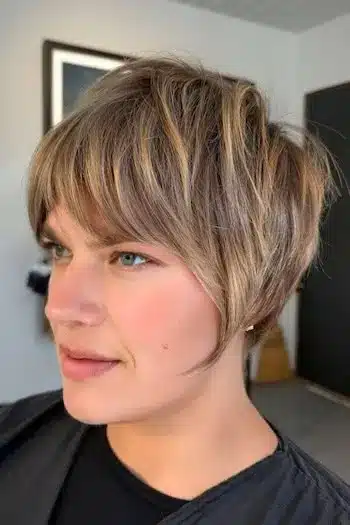 32 Fresh Summer Haircuts You’ll Want To Try This Season 18 Highlighted pixie with soft bangs and warm tones