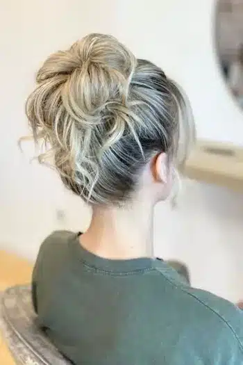32 Fresh Summer Haircuts You’ll Want To Try This Season 30 Messy top knot with loose face-framing strands