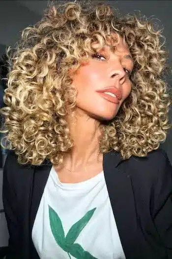 32 Fresh Summer Haircuts You’ll Want To Try This Season 6 Curly long bob with bangs framing the face