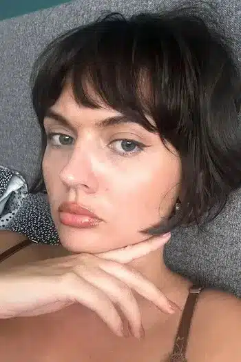 Tousled French bob with feathered layers on a woman with brown hair