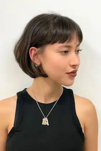 French bob with subtle layers on a woman with brown hair, side view