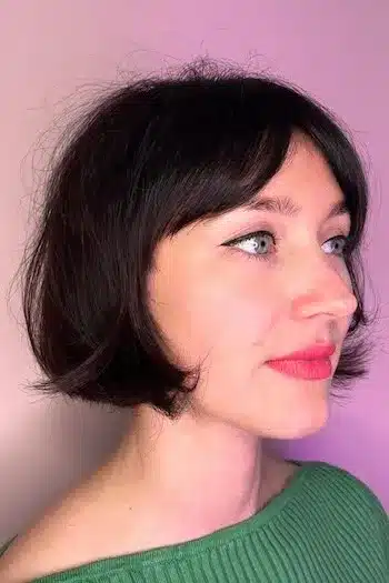 French bob with curtain bangs on a woman with brown hair, side view
