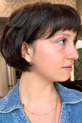 Feathered French bob on a woman with brown hair, side view