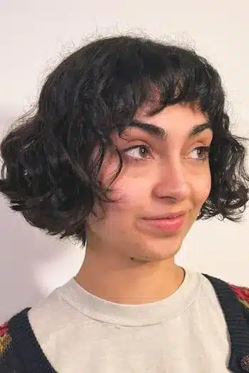 Short curly French bob on a woman with brown hair