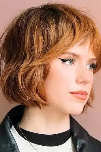 Textured French bob on a woman with reddish-brown hair