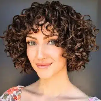 Curly French bob on a woman with short brown hair