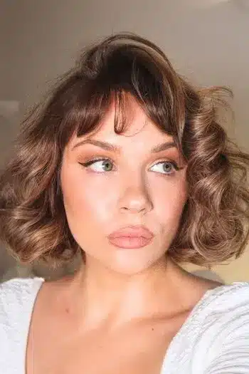 French bob with soft curls on a woman with brown hair