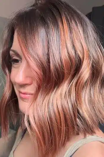 33 Charming Wavy Bob Hairstyles That Women Are Getting In 2026 1 Wavy copper brown lob hairstyle with soft curls framing the face