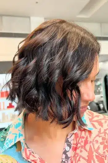 Short wavy bob hairstyle with a side part, profile view