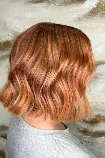 Copper blunt wavy bob with a clean edge, side view