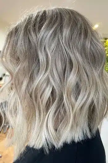 Ash blonde wavy lob with soft texture, side profile