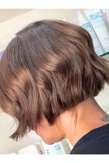 Short blunt wavy bob with a clean cut, side profile