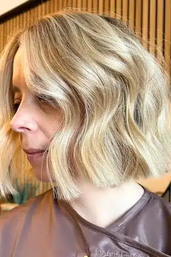 Blunt blonde wavy bob with a sharp, clean edge