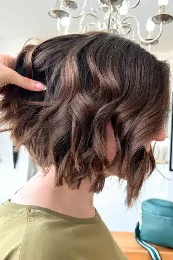 Chocolate brown textured bob with subtle highlights, side view