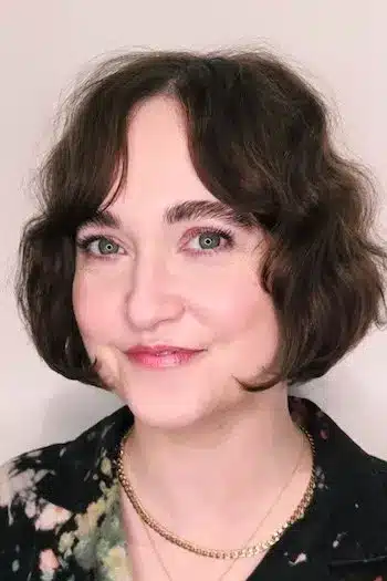 Chin-length wavy bob with soft curtain bangs framing the face