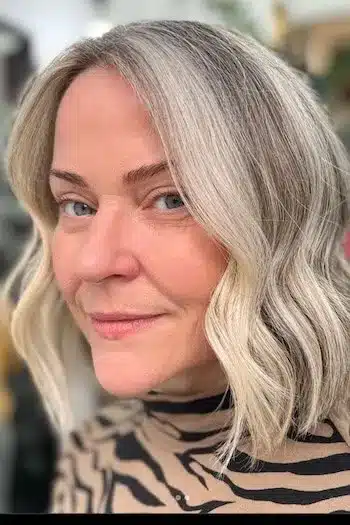 Face-framing wavy bob with a natural gray blend for a modern look