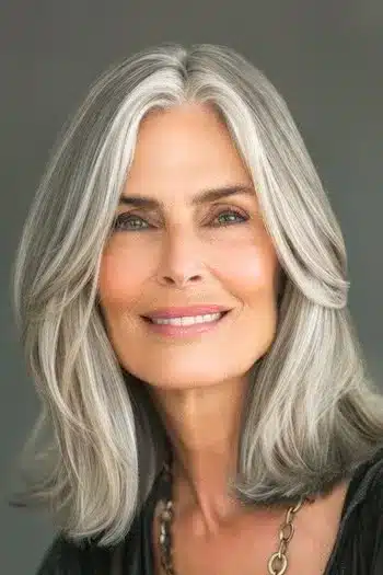 Face-framing lob on a smiling older woman with natural gray hair