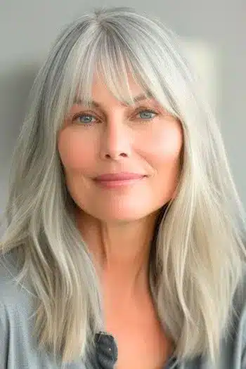 Lob with bangs on a smiling older woman with natural gray hair