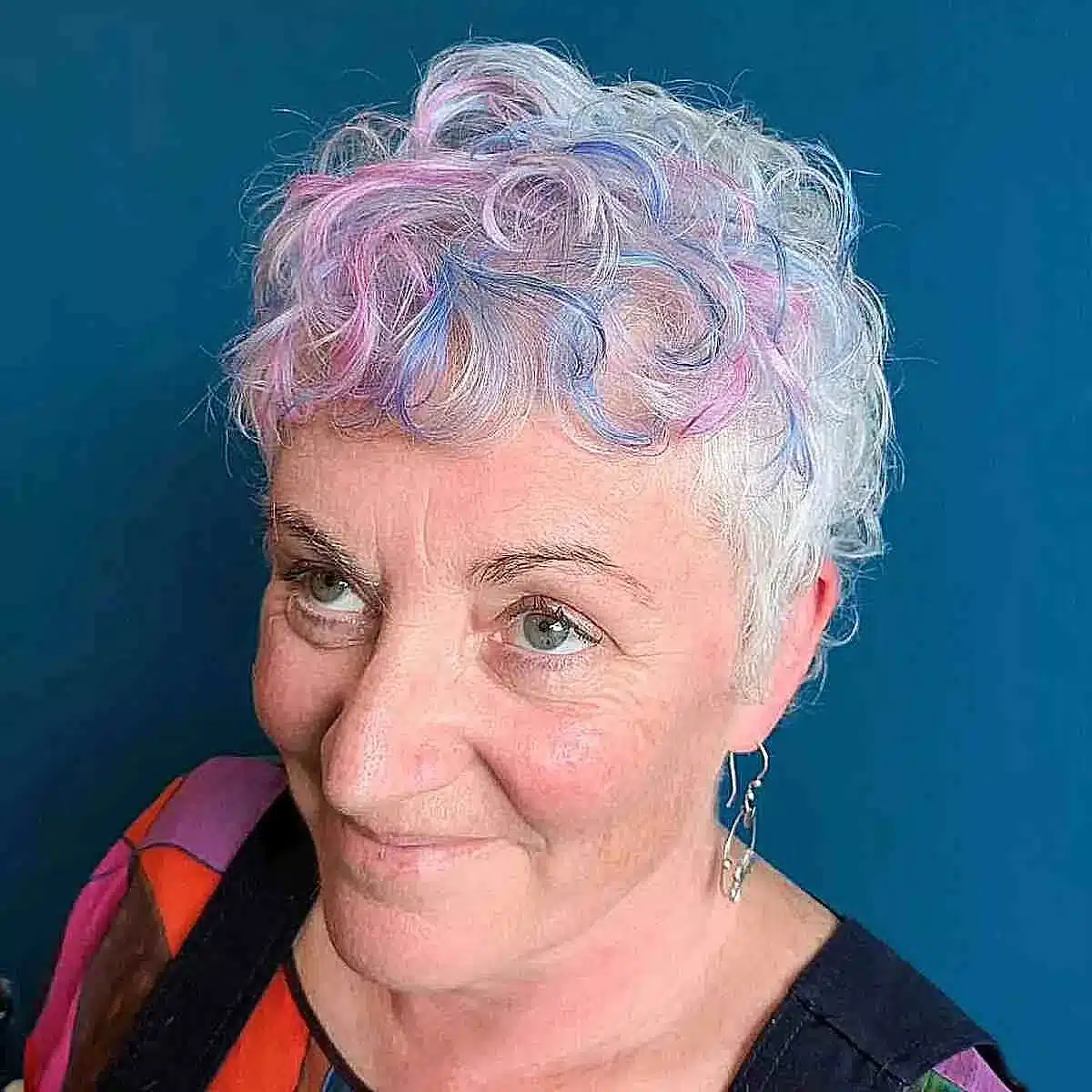 51 Cutest Wash and Wear Haircuts for Women Over 50 8 Wash-and-wear curled pixie with pink and blue accents for women over 50