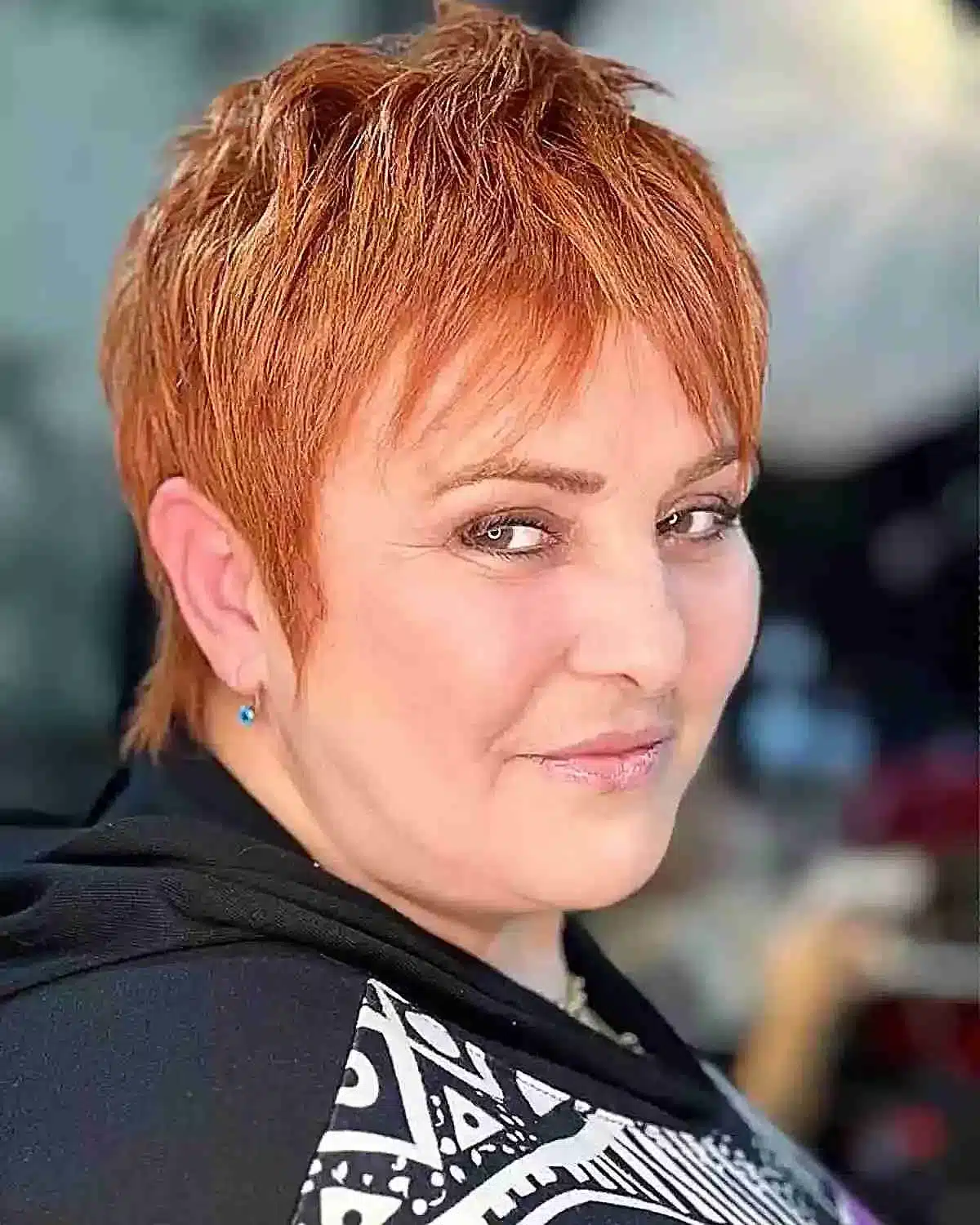 51 Cutest Wash and Wear Haircuts for Women Over 50 13 Copper pixie with shorter pieces for women over 50 with rounder face shapes
