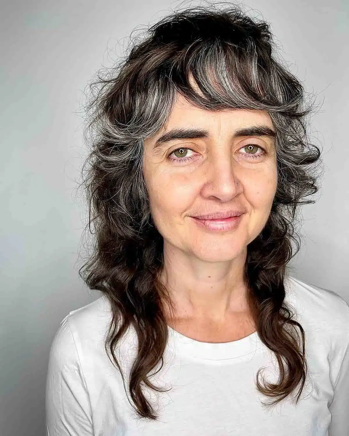 51 Modern Medium Shaggy Hairstyles Women Over 60 Can Pull Off 51 Medium-length curly shag with bangs for dark hair, part of 51 Modern Medium Shaggy Hairstyles Women Over 60 Can Pull Off