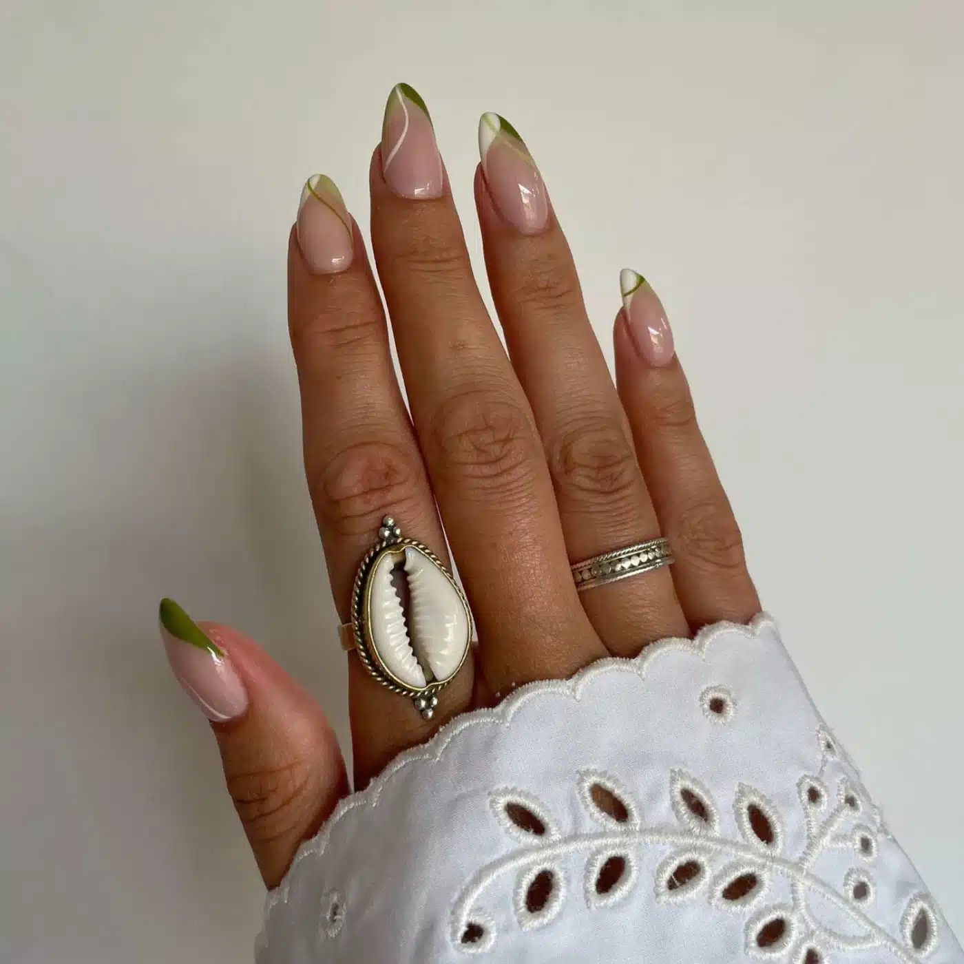 18 Olive Green Nail Ideas for an Unexpected Spring Manicure 17 Olive green and white French tips with swirl accents