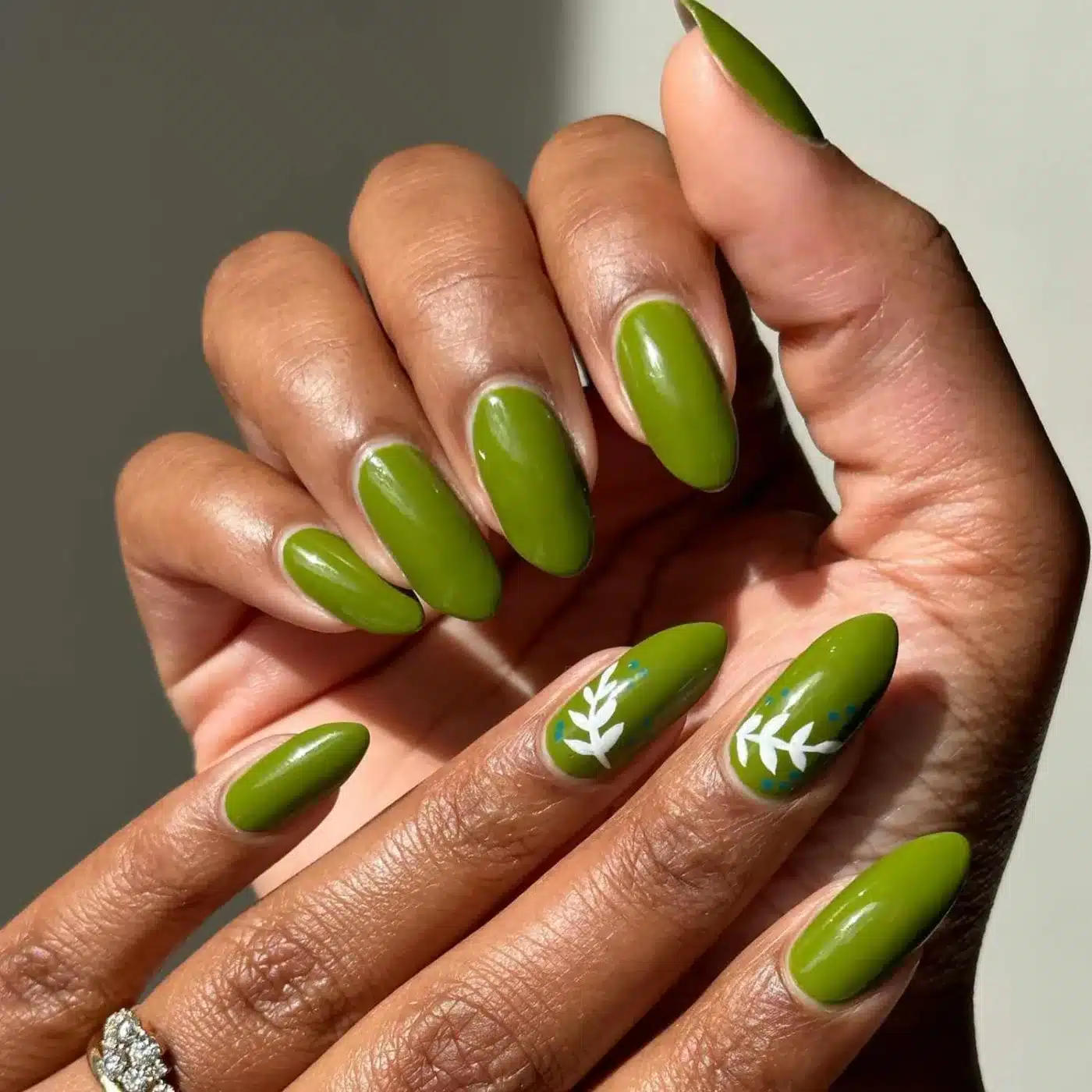 18 Olive Green Nail Ideas for an Unexpected Spring Manicure 5 Olive green nails with white botanical leaf designs