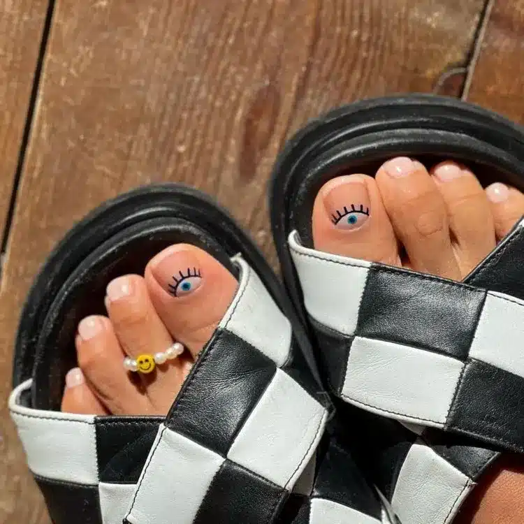 39 Cute Pedicure Ideas for Every Season 33 Nude pedicure with eye nail art